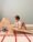 A determined baby boy climbs a wooden Pikler triangle with a ramp, building strength, coordination, and confidence through active play. The setup encourages gross motor development and independent exploration.