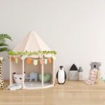 A calm and relaxing child's playroom with a play tent and a variety of stuffed animals on the ground.