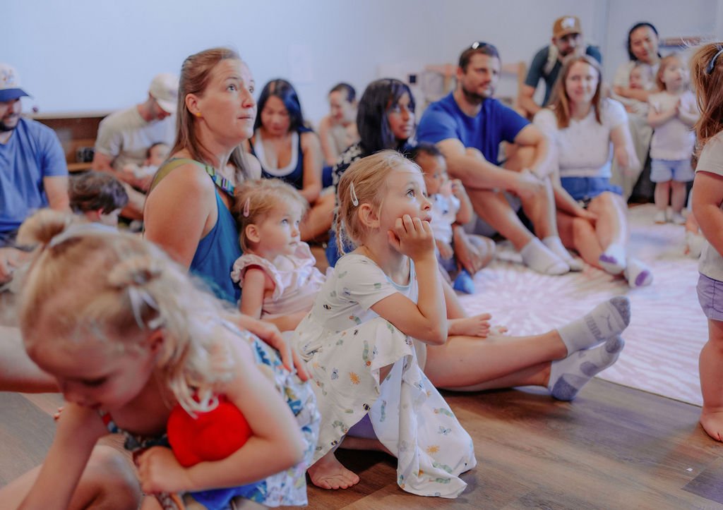 Families gathered for a storytime event in the Baby University parent lounge
